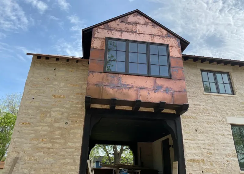 Copper metal panel facade on a stone building for Skylight Installation in Boiling Springs