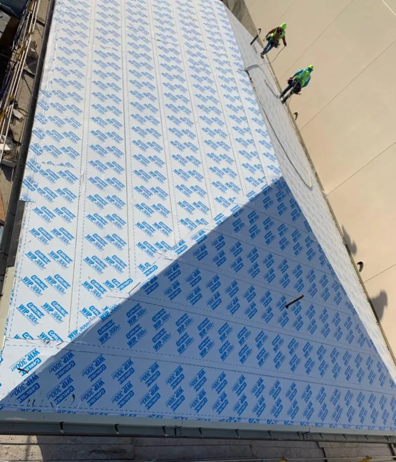 Professional roofers installing underlayment on a metal roof in Boiling Springs